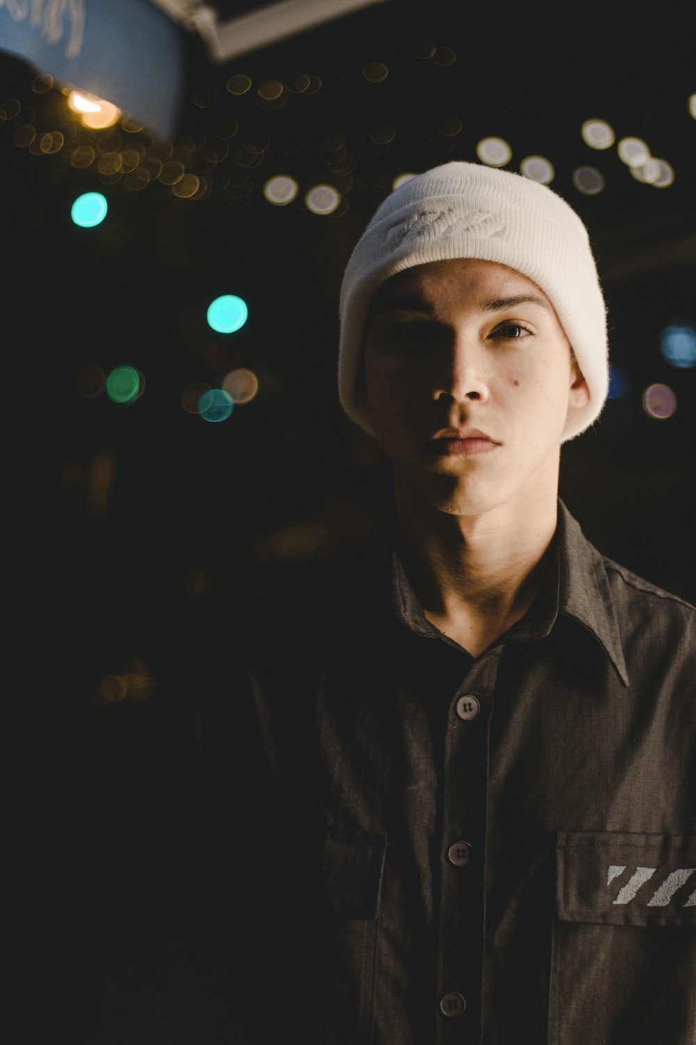 standing man wearing white knitted cap