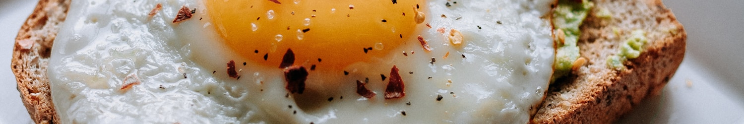 bread with sunny side-up egg served on white ceramic plate