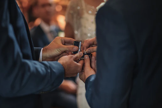 Elegant couple exchanging rings during a civil wedding ceremony in a softly decorated venue.