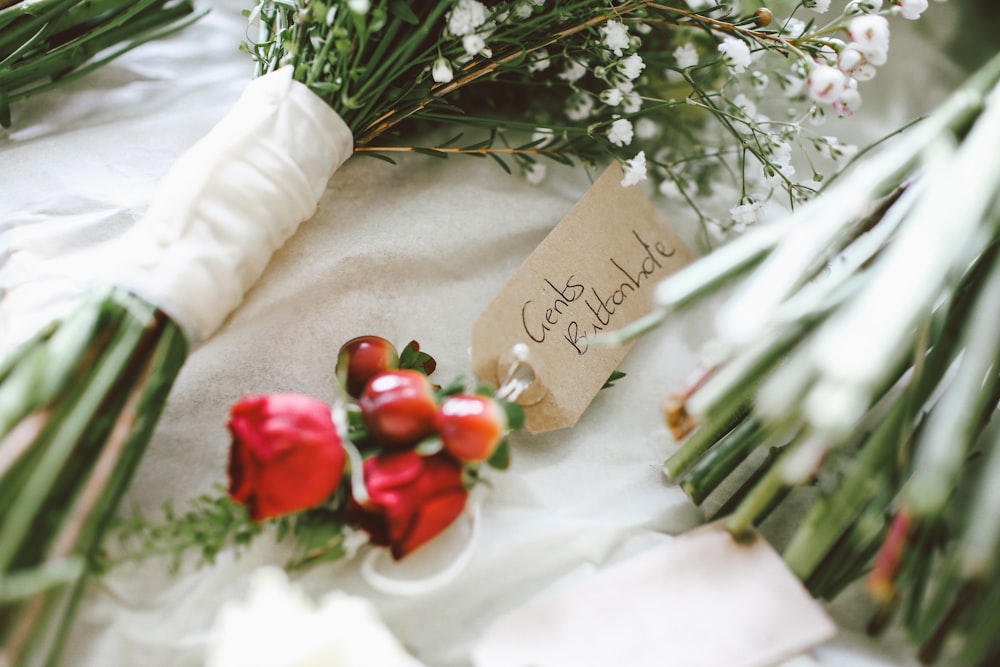 white flower bouquet on white textile