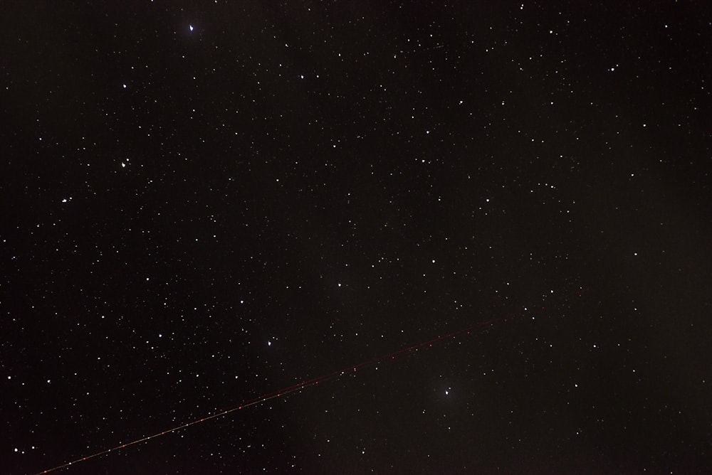 the night sky with stars and a long line of lines