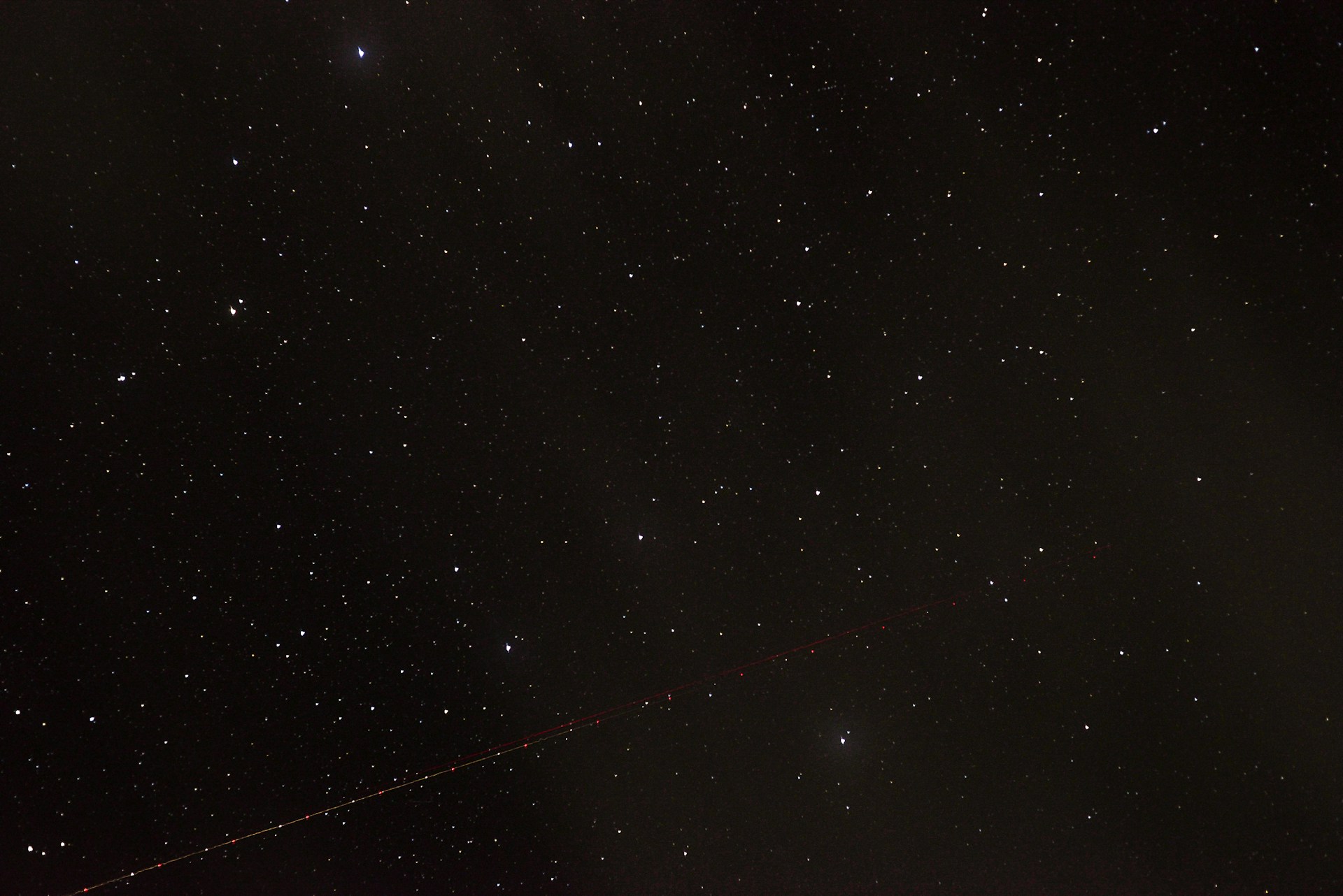 the night sky with stars and a long line of lines