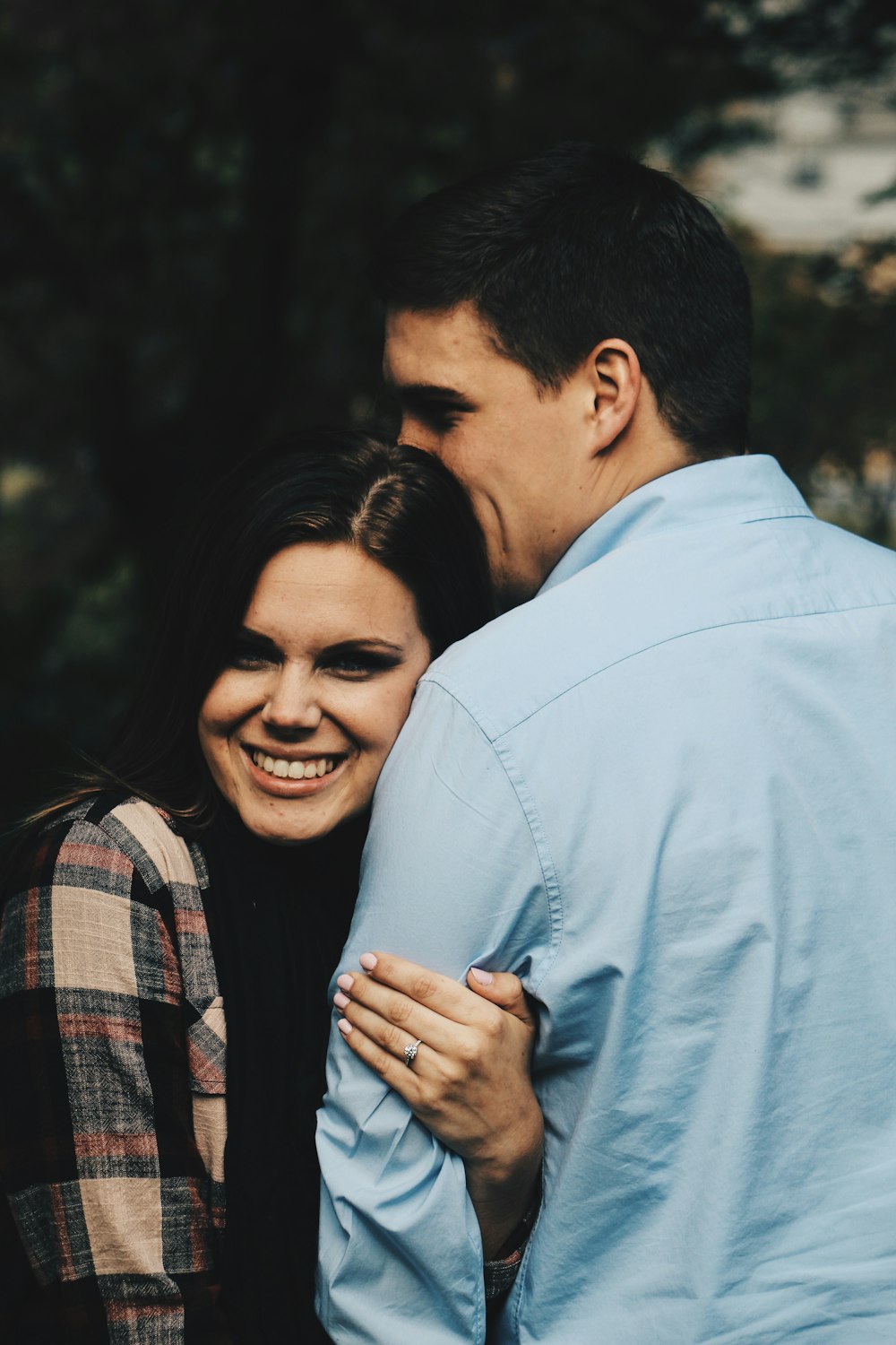 woman holding arms of man