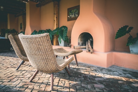 two brown wicker chairs