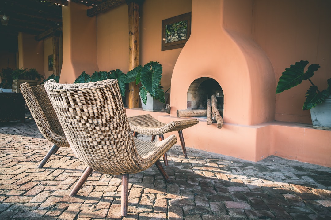 two brown wicker chairs, A lifestyle shot on the terrace of a winery in Peru.