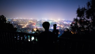 A vibrant photo of a travel influencer capturing a scenic cityscape with a camera.