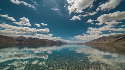 The tranquil Humantay lagoon reflecting the blue sky and mountain peaks in the distance