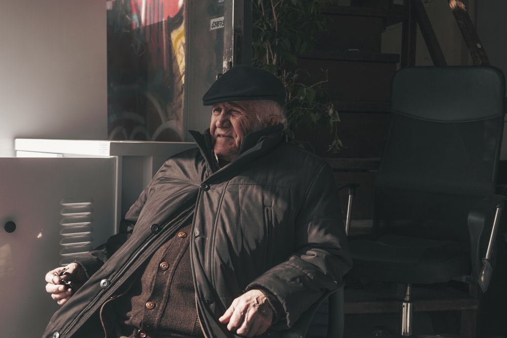 man sitting on black chair during daytime