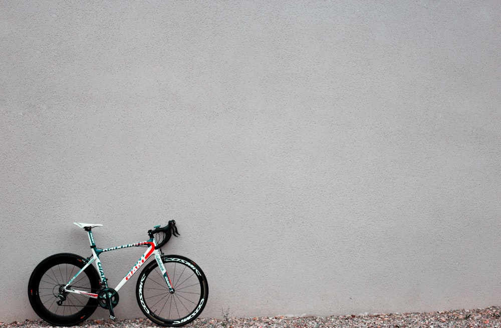 black and white road parked beside white painted wall