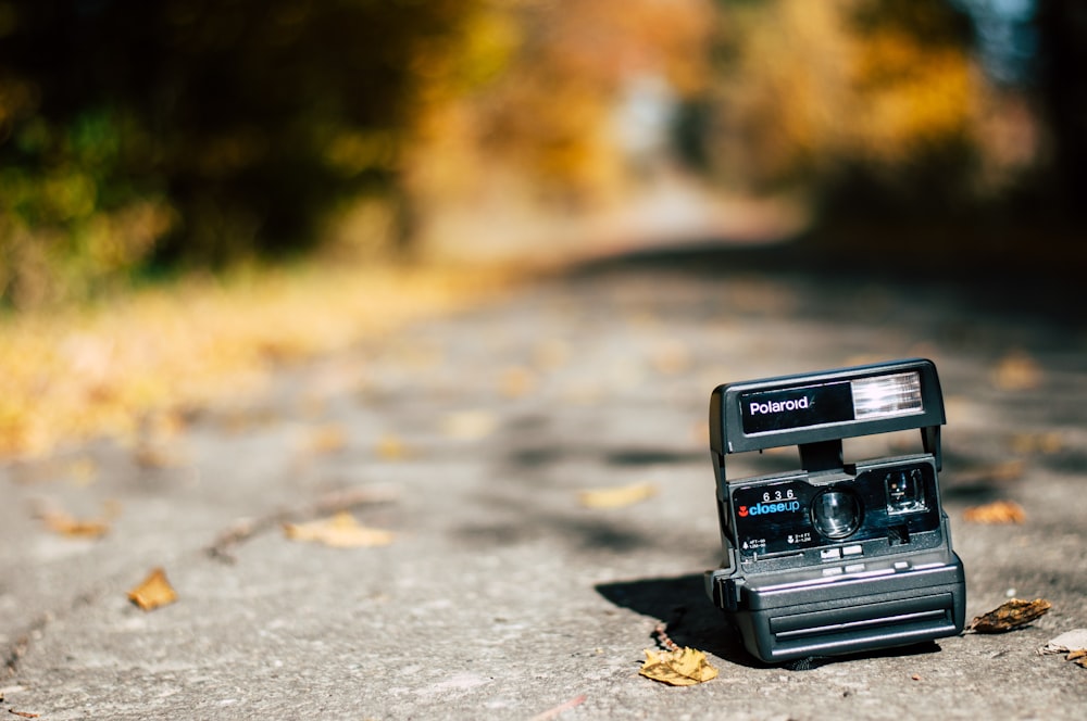 selective focus photography of black Polaroid land camera on land