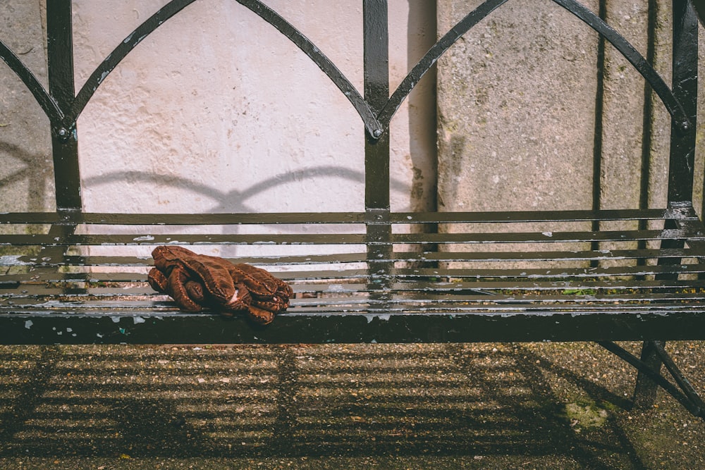 brown textile on black metal bench