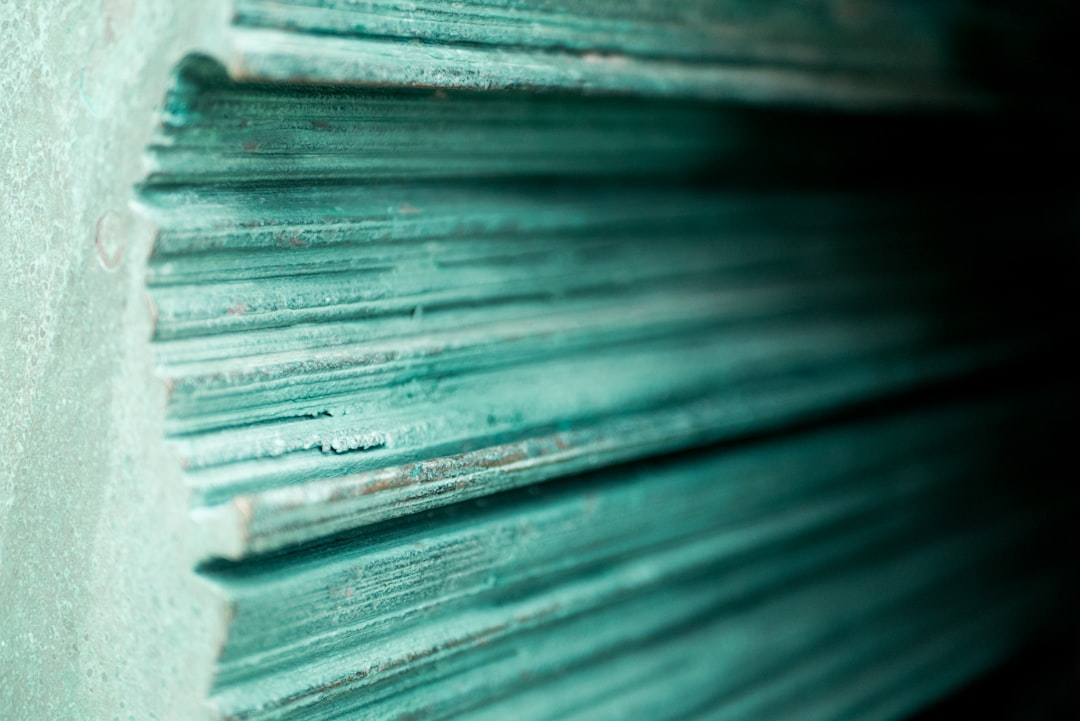 a close up of a stack of metal sheets,