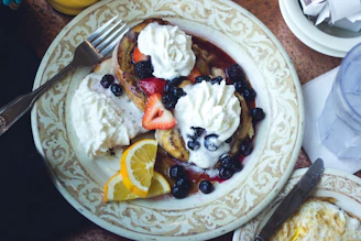 An inviting breakfast spread featuring gluten-free pancakes topped with maple syrup and fresh fruit.