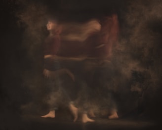 a blurry photo of a person walking through smoke