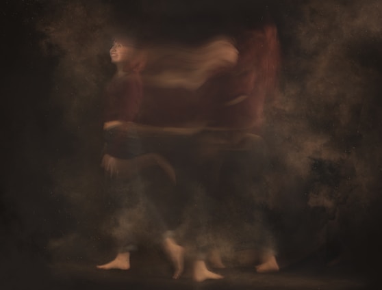a blurry photo of a person walking through smoke