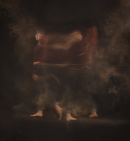 a blurry photo of a person walking through smoke