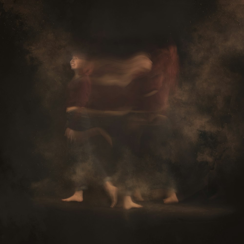 a blurry photo of a person walking through smoke