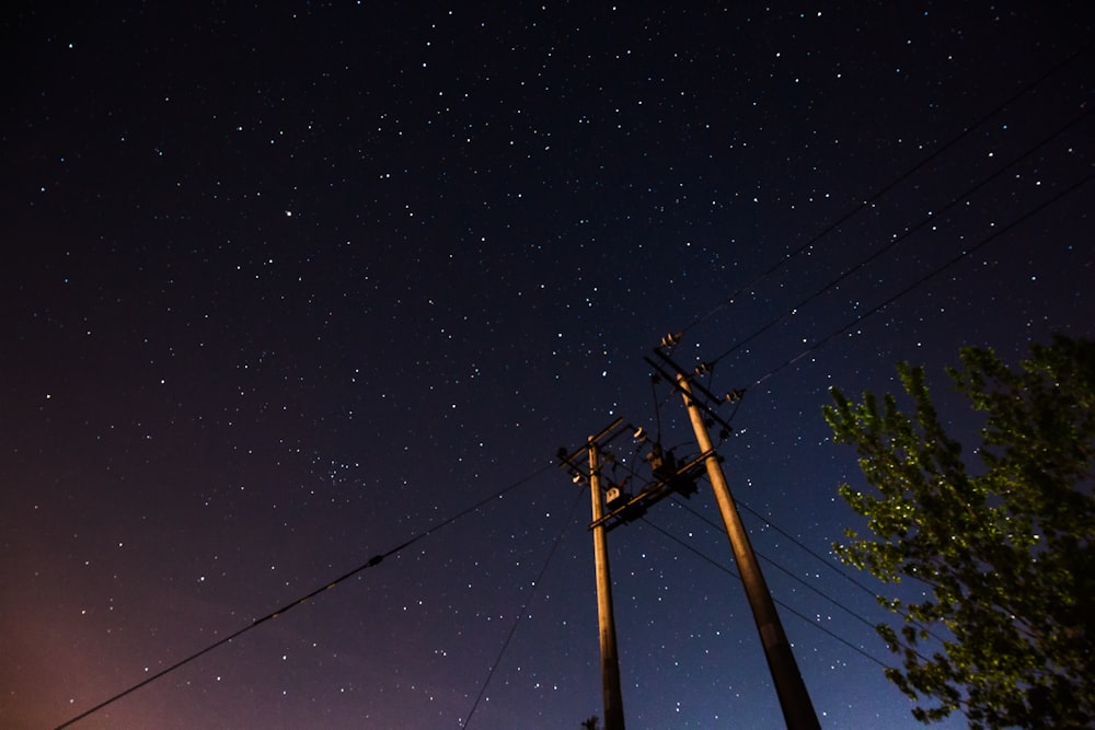 two gray street posts under dark sky