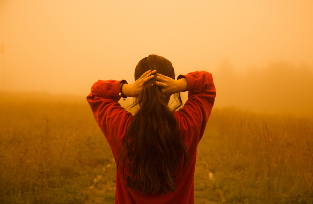 woman standing on green grass during daytime