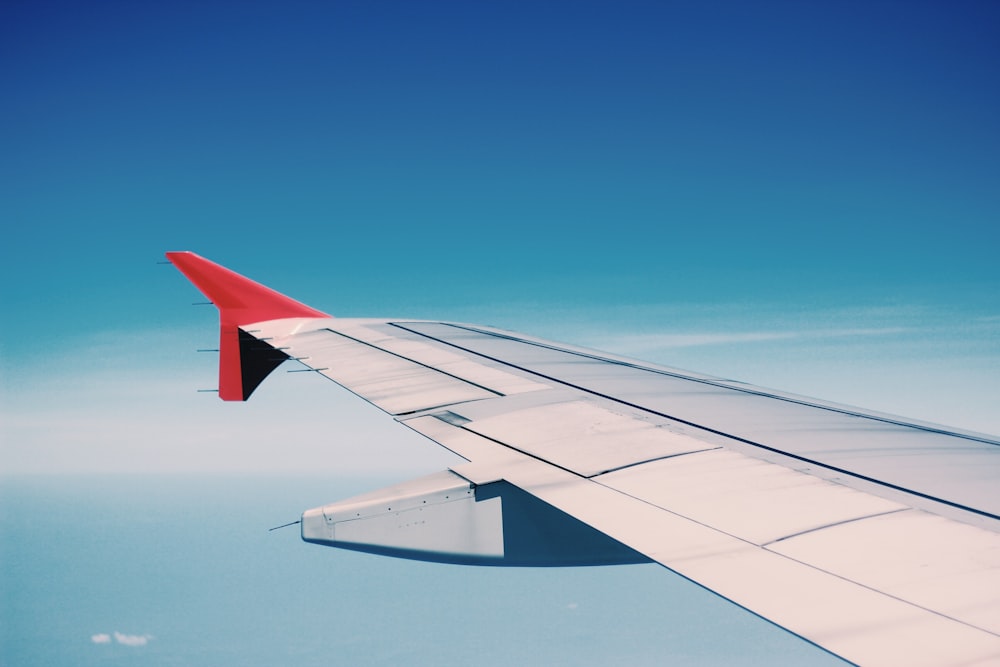 white and red airplane wing