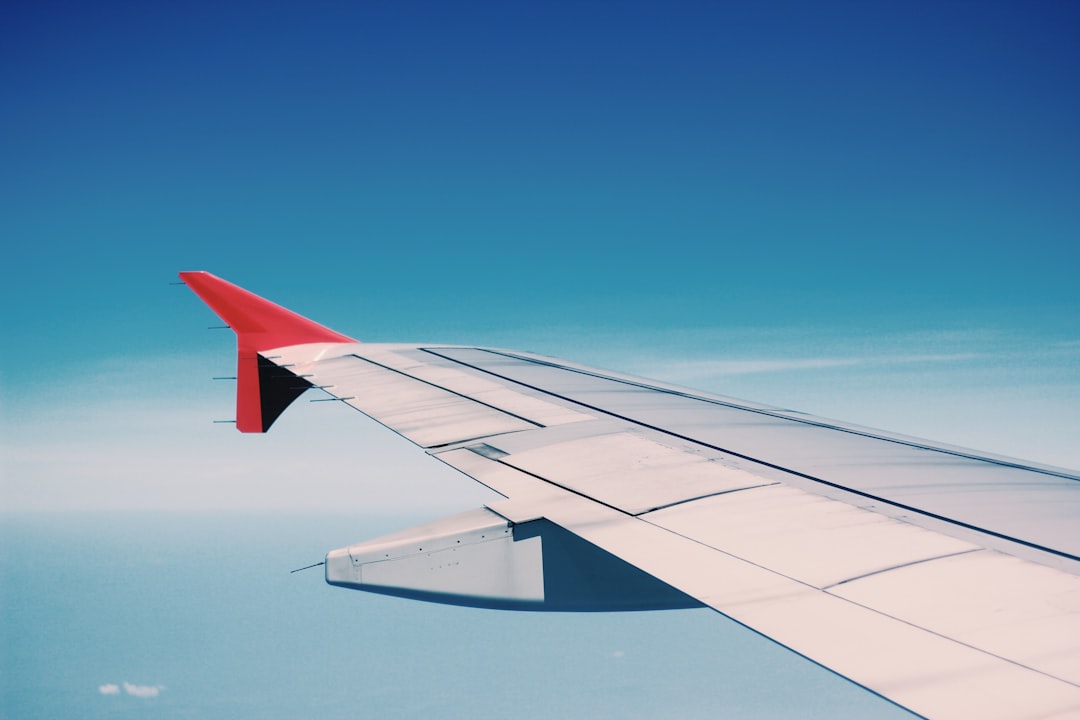 white and red airplane wing, Look at the wing