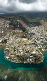 aerial view of houses on mountain and lake