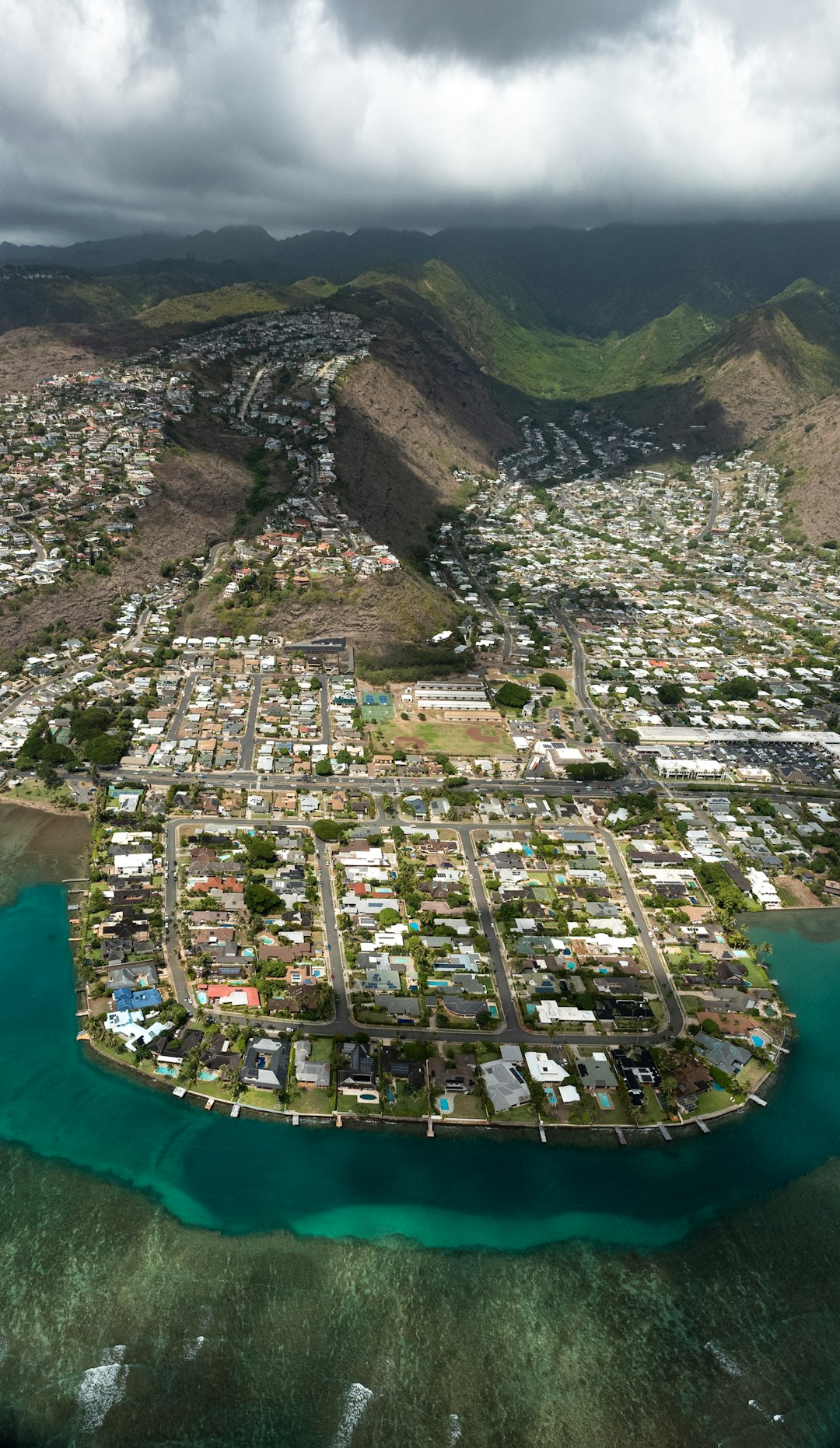aerial view of houses on mountain and lake
