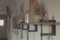 A decorative wall shelf displaying various decorative items.