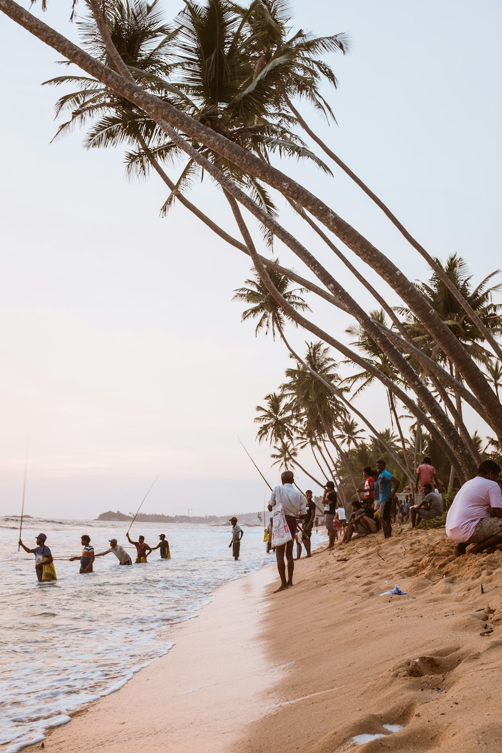 group of people standing in sea shore