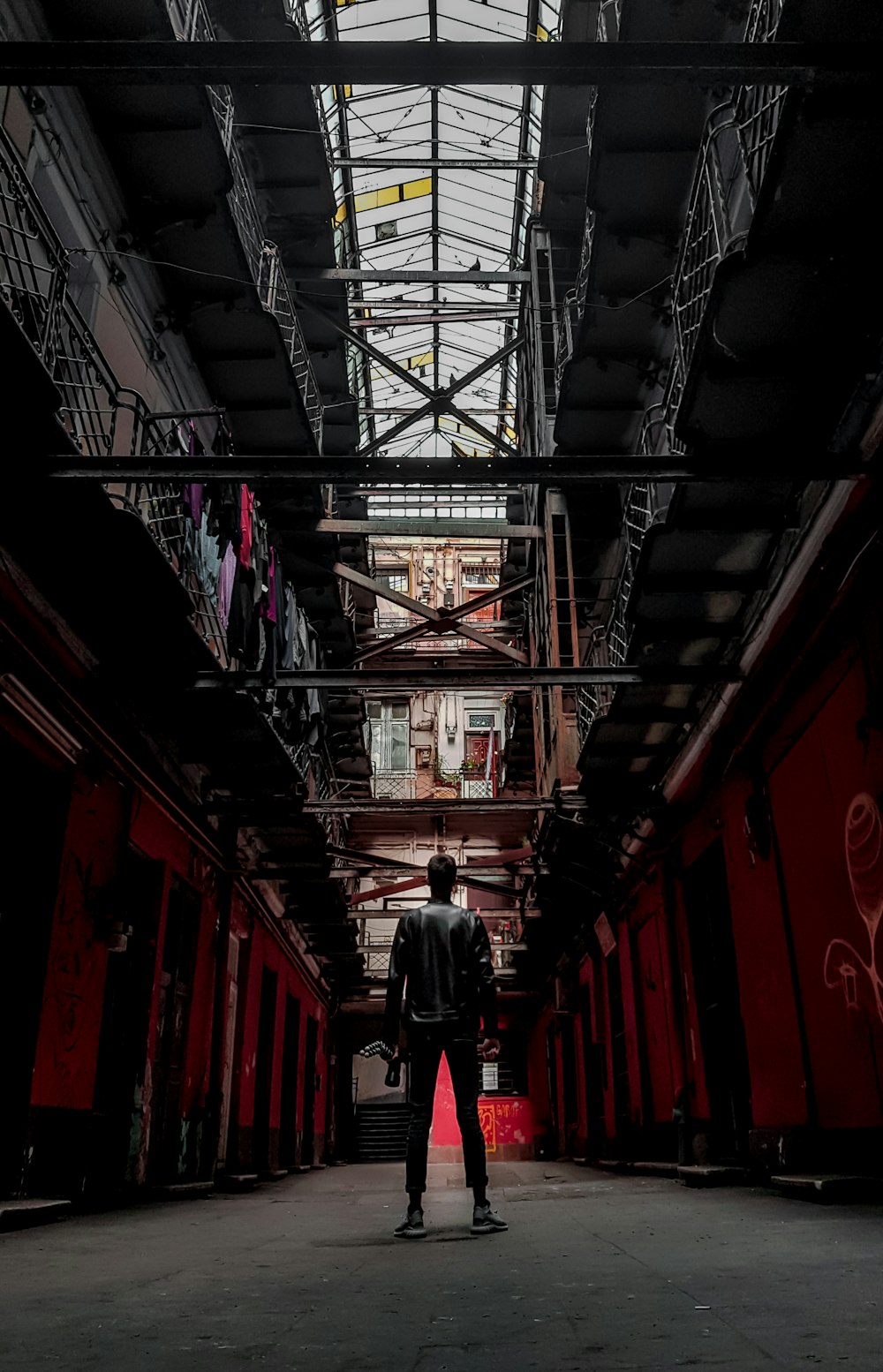 man standing between apartment building