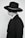 A person dressed in a dark suit and a wide-brimmed hat, wearing sunglasses. The attire is formal and the hat has a decorative band.