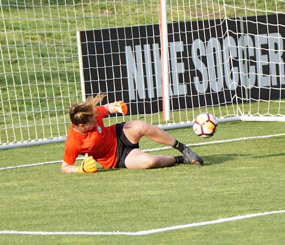 goal keeper lying on grass