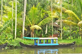 A colorful traditional boat sailing near a tropical island shore