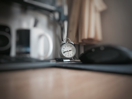 round grey alarm clock at 2:40