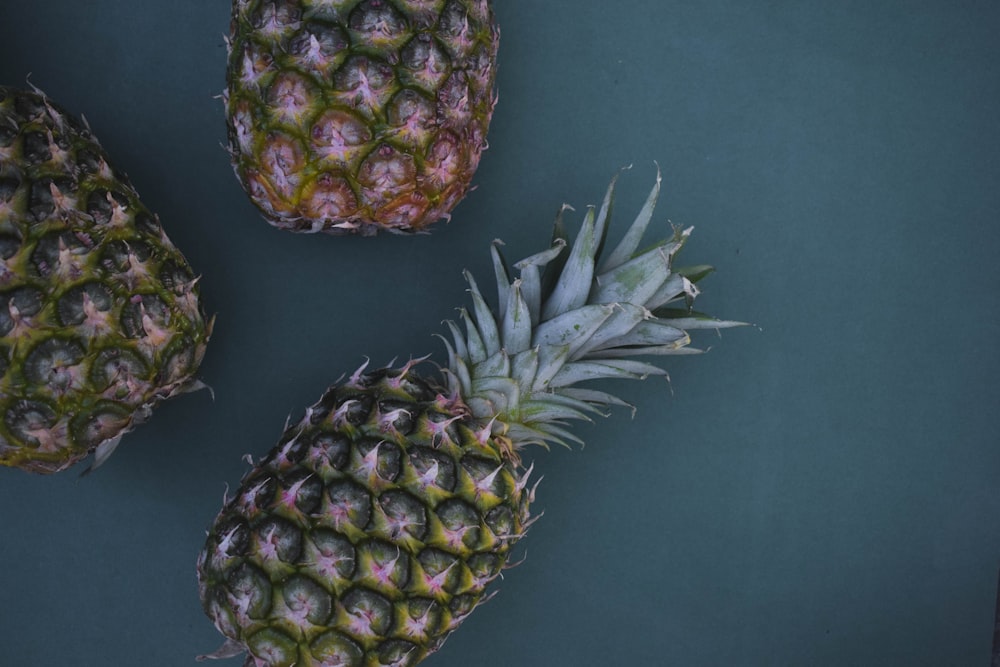 flat-lay photography of three pineapples