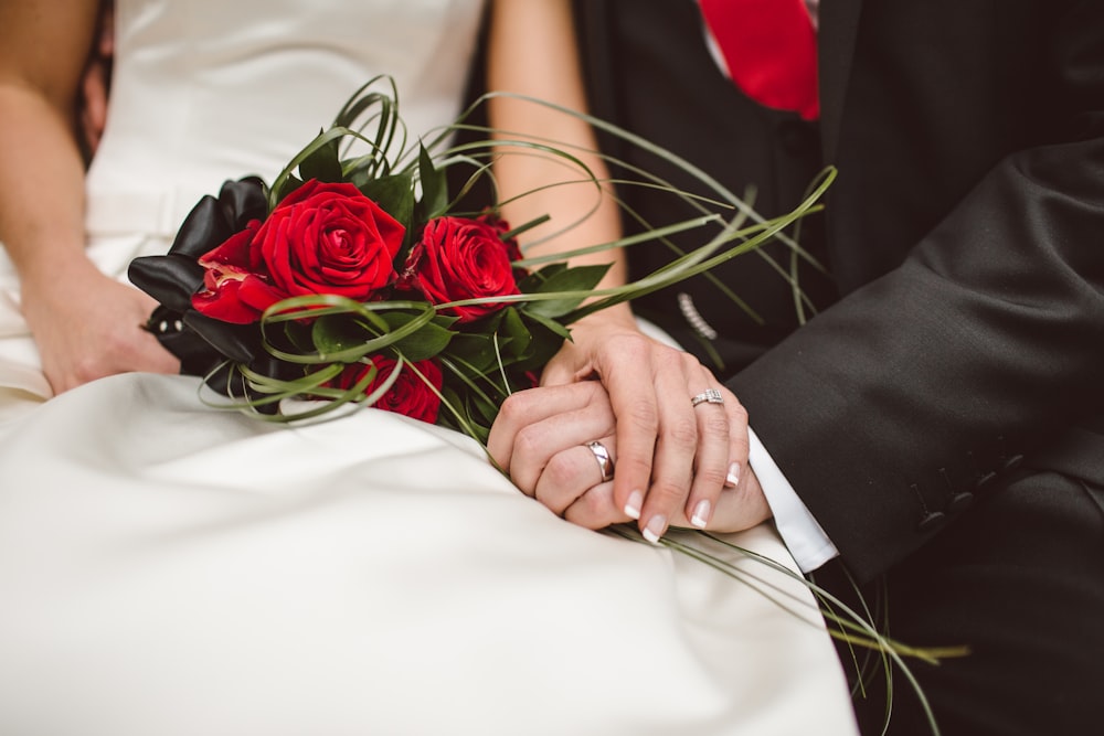 man holding red flowers