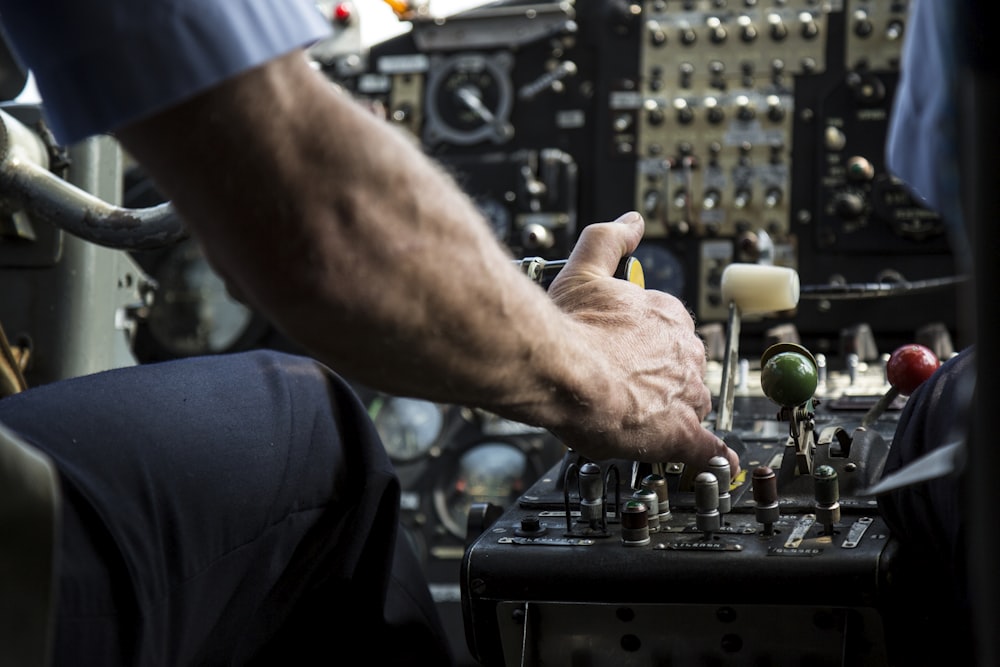 person operating black audio mixer