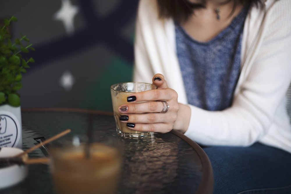 woman holding a clear drinking glass