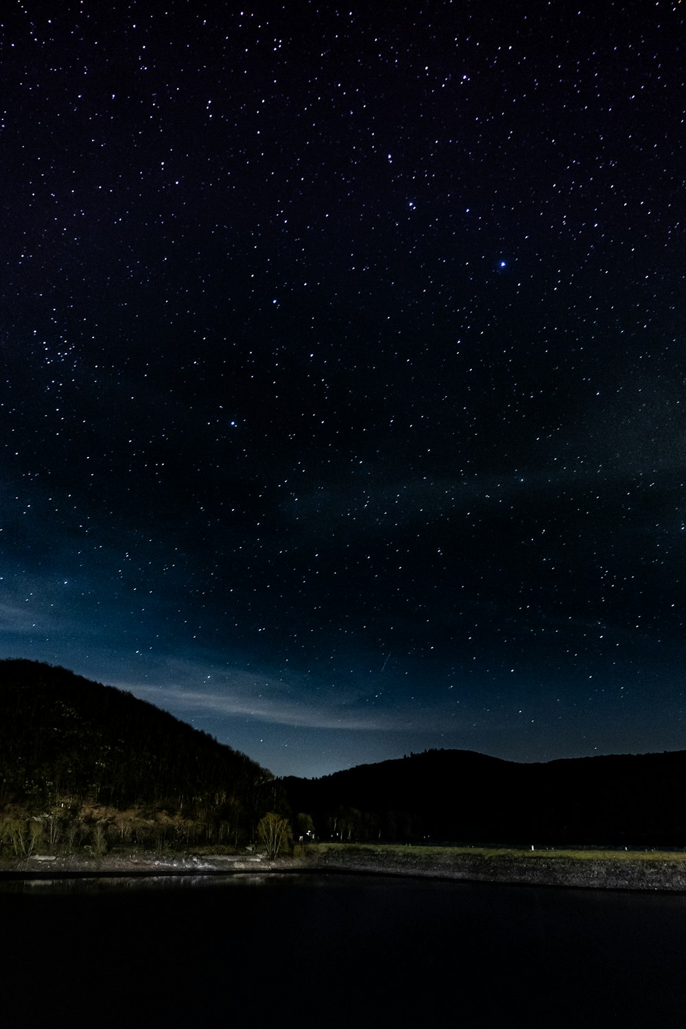 mountains under starry sky during nighttime