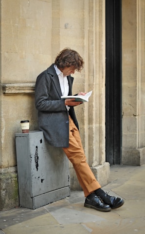 man sitting beside cup of coffee