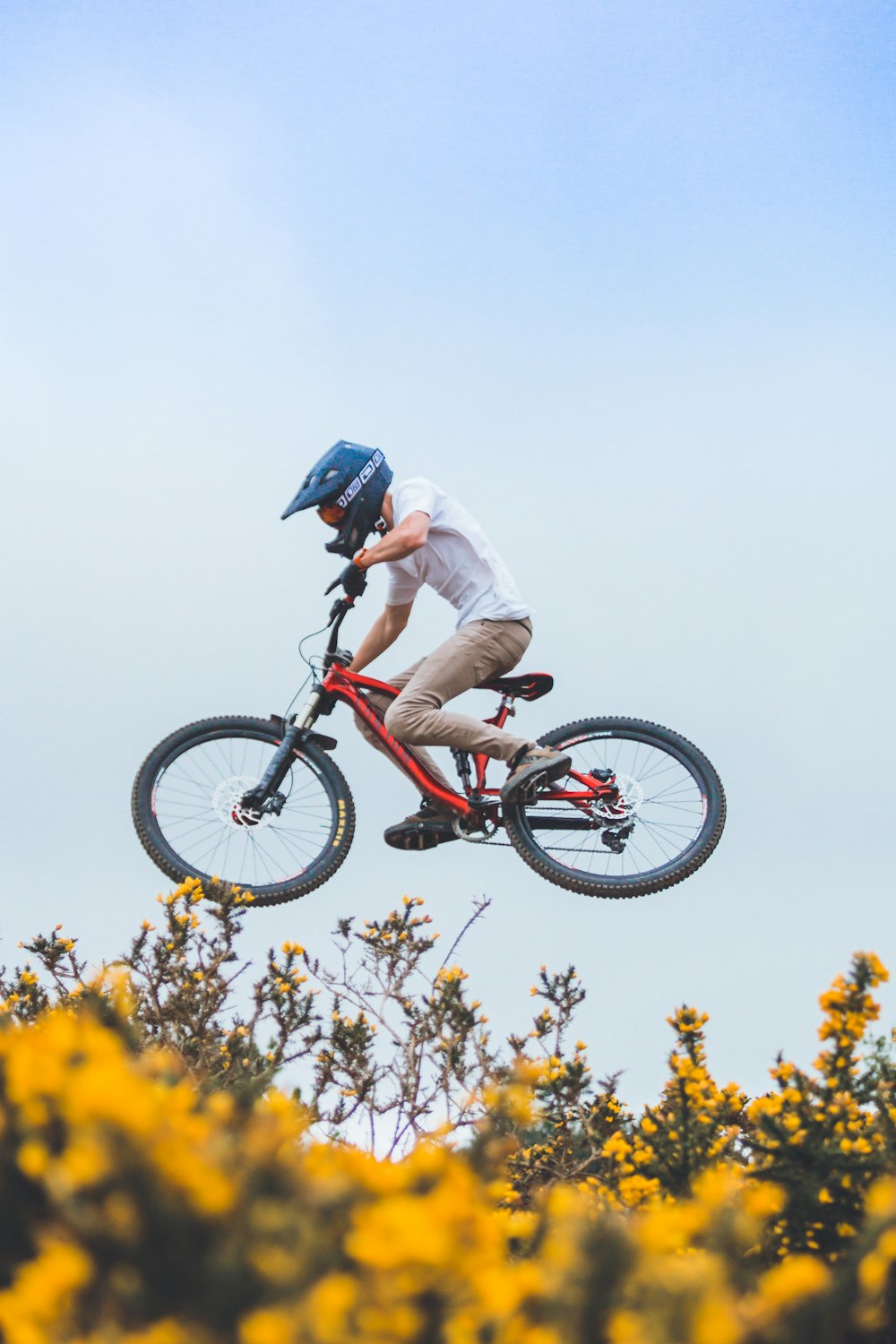 man wearing helmet riding bicycle