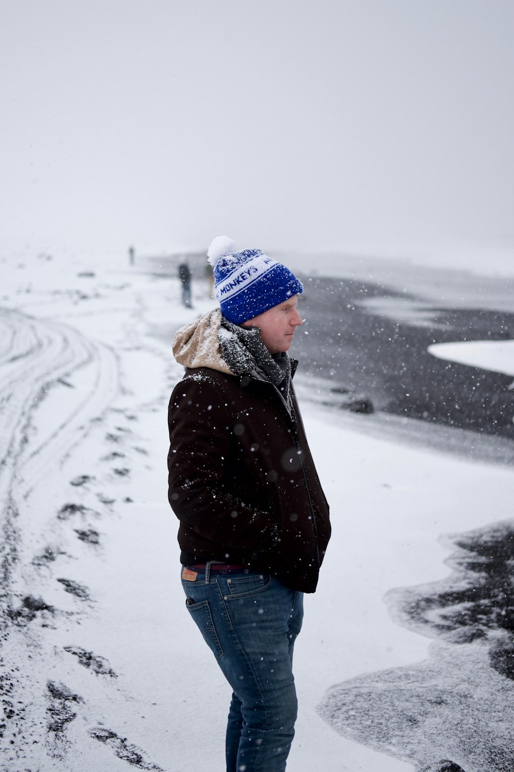 man standing on snow during winter