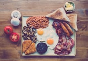 fried ham, egg, bread with beans and red tomato slice