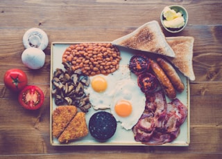 fried ham, egg, bread with beans and red tomato slice