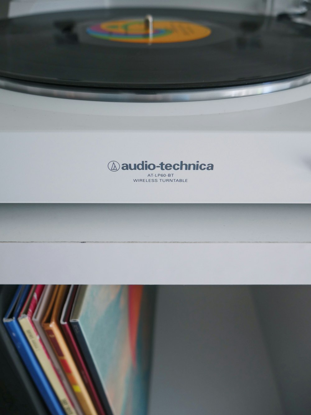 white Audio-Technica wireless turntable near vinyl record sleeve