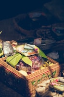 Handwoven basket filled with various handcrafted fruit decorations in a cozy shop setting.