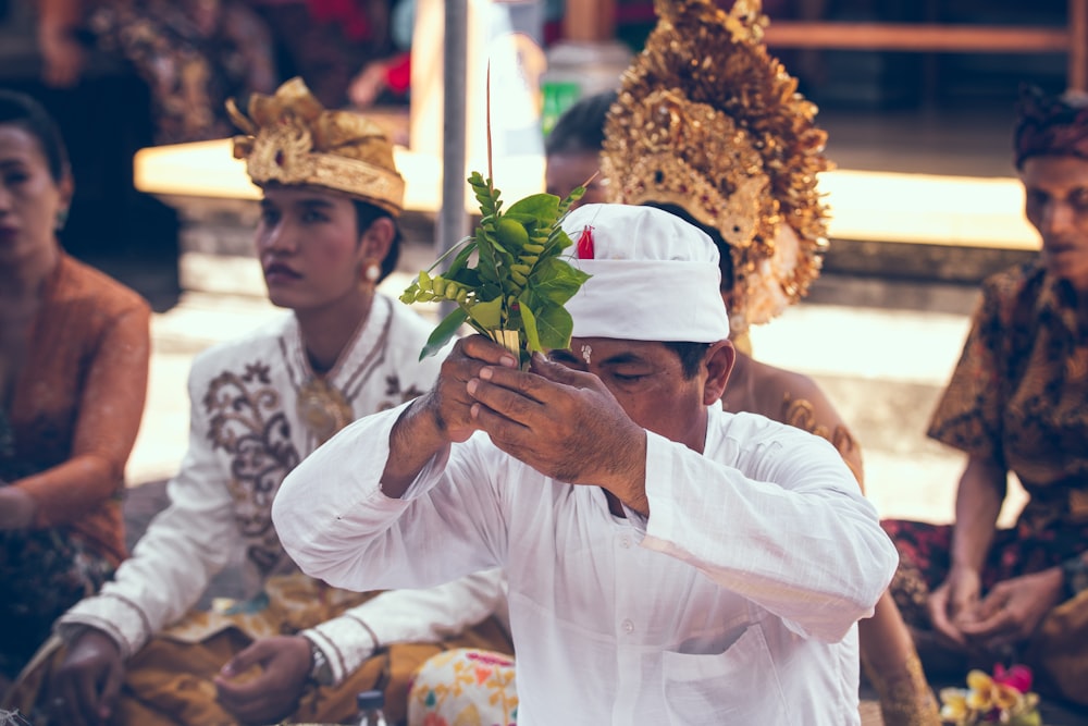 man holding green plant