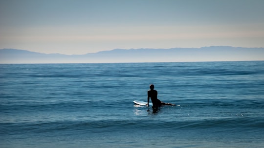 landscape photo lens of person surfing board in Newport Beach United States