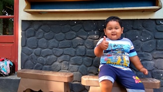 A happy child giving a thumbs-up after completing a homework task with AI help.