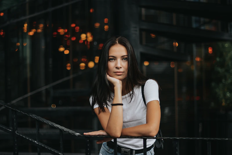 woman leaning casually on a black handrail